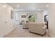 Bright living room with neutral-toned furnishings, a TV, and a sliding glass door to the outside at 20855 Park Hollow Dr, Parker, CO 80138