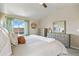 Comfortable main bedroom with neutral tones, a ceiling fan, lots of natural light, and an ensuite bathroom at 20855 Park Hollow Dr, Parker, CO 80138
