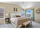 Bright main bedroom featuring a large bed, bench, neutral tones, and ample natural light at 20855 Park Hollow Dr, Parker, CO 80138