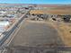 An aerial view shows an expansive property next to a road, highlighting its location and potential at 724 County Road 37, Brighton, CO 80603