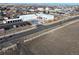 Aerial view of a fire station along a country road with a white fence at 724 County Road 37, Brighton, CO 80603