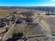 Aerial view of rural farm with farm land, fencing and large trees at 724 County Road 37, Brighton, CO 80603