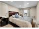 Comfortable bedroom with a large, dark wood headboard, soft lighting, and a window view at 724 County Road 37, Brighton, CO 80603