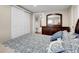 Comfortable bedroom with plush patterned bedding, dresser, and an ensuite bathroom at 724 County Road 37, Brighton, CO 80603
