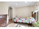 Cozy bedroom features a cheerful bedspread and natural light from window with wooden blinds at 724 County Road 37, Brighton, CO 80603