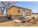 Inviting home with stone accents, a manicured lawn, and a quaint front porch at 724 County Road 37, Brighton, CO 80603