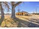 Charming home with a covered porch and inviting front yard, nestled amongst mature trees at 724 County Road 37, Brighton, CO 80603