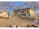 Charming home exterior features stone accents, a well-manicured lawn, and a welcoming entrance at 724 County Road 37, Brighton, CO 80603