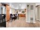 Eat-in kitchen featuring stainless steel appliances, granite countertops, wood cabinets, and wood floors at 724 County Road 37, Brighton, CO 80603