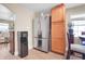 Kitchen area with stainless steel refrigerator, wooden cabinets, and a built-in water dispenser at 724 County Road 37, Brighton, CO 80603