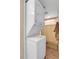 Efficient laundry area featuring a stacked washer and dryer with access to the shower at 724 County Road 37, Brighton, CO 80603