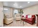 Bright living room with wood floors, lots of light, cozy seating, and neutral walls at 724 County Road 37, Brighton, CO 80603