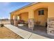 Covered patio featuring stone pillars, providing a comfortable outdoor living space at 724 County Road 37, Brighton, CO 80603