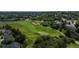 Aerial view of community featuring a well-manicured golf course surrounded by beautiful homes and mature trees at 171 October Pl, Castle Rock, CO 80104