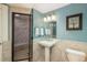 Bright bathroom featuring a walk-in shower, white vanity, and custom mirror at 171 October Pl, Castle Rock, CO 80104