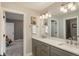 Bright bathroom features a double sink vanity and a large mirror at 171 October Pl, Castle Rock, CO 80104