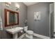 Cozy bathroom featuring a modern sink, a toilet, and neutral decor at 171 October Pl, Castle Rock, CO 80104