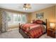 Comfortable bedroom with a window, shutters, and a cozy striped comforter at 171 October Pl, Castle Rock, CO 80104