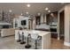 Well-lit kitchen features a stone backsplash, breakfast bar, and modern appliances at 171 October Pl, Castle Rock, CO 80104