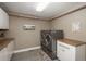 Well-lit laundry room with modern washer and dryer and custom cabinets at 171 October Pl, Castle Rock, CO 80104