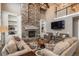 Inviting living room featuring a stone fireplace, built-in shelves, and comfortable seating at 171 October Pl, Castle Rock, CO 80104
