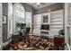 Bright office with custom built-ins, large window with shutters, and decorative rug creating an inviting workspace at 171 October Pl, Castle Rock, CO 80104