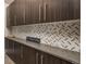 Pantry area with custom cabinetry and backsplash at 171 October Pl, Castle Rock, CO 80104