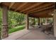 Covered patio featuring string lights, stone pillars, and outdoor swing at 171 October Pl, Castle Rock, CO 80104