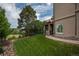 Well-maintained backyard featuring lush lawn, mature trees, and a side yard for privacy and serenity at 171 October Pl, Castle Rock, CO 80104