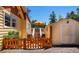 Side view of the property with a detached shed and a deck featuring an outdoor dining set with umbrella at 4805 S Blue Spruce Rd, Evergreen, CO 80439