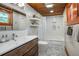 Stylish bathroom featuring a modern vanity, wood ceiling and a shower-over-tub at 4805 S Blue Spruce Rd, Evergreen, CO 80439