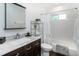 Clean bathroom with a vanity, mirror, bathtub, and chrome accessories at 4805 S Blue Spruce Rd, Evergreen, CO 80439