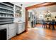 A classic butler's pantry features an open shelf, a sink, and stainless steel refrigerator at 4805 S Blue Spruce Rd, Evergreen, CO 80439
