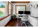 Bright home office with hardwood floors, dual monitors, a comfortable workspace, and natural light at 4805 S Blue Spruce Rd, Evergreen, CO 80439