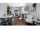 Modern kitchen with stainless steel appliances, gray cabinetry, and an eat-in dining area at 4805 S Blue Spruce Rd, Evergreen, CO 80439