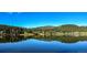 Scenic lake view reflecting the clear sky and dense forest at 4805 S Blue Spruce Rd, Evergreen, CO 80439