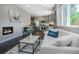 Open-concept living space with a modern fireplace, comfortable seating, and kitchen view at 4805 S Blue Spruce Rd, Evergreen, CO 80439