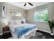Cozy main bedroom with large windows, a ceiling fan, and natural light at 4805 S Blue Spruce Rd, Evergreen, CO 80439