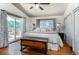 Bright main bedroom with hardwood floors, a sliding glass door, and outdoor deck at 4805 S Blue Spruce Rd, Evergreen, CO 80439