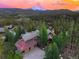 Gorgeous aerial perspective of a mountain residence with picturesque scenery in the background at 805 Highfield Trl, Breckenridge, CO 80424