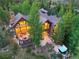 Beautiful home in wooded setting featuring outdoor living spaces, stone patio, and hot tub at 805 Highfield Trl, Breckenridge, CO 80424