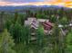 Overhead shot of a private residence nestled amidst lush greenery with mountain views at 805 Highfield Trl, Breckenridge, CO 80424