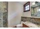 Updated bathroom featuring stone finishes, updated vanity, and glass shower at 805 Highfield Trl, Breckenridge, CO 80424