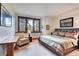 Bright bedroom featuring a cozy reading chair, beautiful views, and comfortable bedding at 805 Highfield Trl, Breckenridge, CO 80424