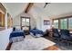Bright bedroom with beamed ceilings, hardwood floors, and large windows overlooking lush wooded landscaping at 805 Highfield Trl, Breckenridge, CO 80424