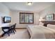 Relaxing bedroom featuring a large window, comfortable bedding, and a dedicated workspace at 805 Highfield Trl, Breckenridge, CO 80424