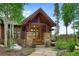 Beautiful stone and timber entryway with glass-paneled wood door and landscaped pathway at 805 Highfield Trl, Breckenridge, CO 80424