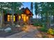 Inviting home entrance with stone pillars, pathway, and soft outdoor lighting at 805 Highfield Trl, Breckenridge, CO 80424
