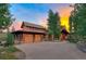 Gorgeous home exterior with a spacious driveway, timber and stone accents, and inviting entryway at 805 Highfield Trl, Breckenridge, CO 80424