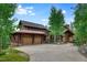Stunning front exterior showcasing a spacious driveway and inviting entryway of this mountain home at 805 Highfield Trl, Breckenridge, CO 80424